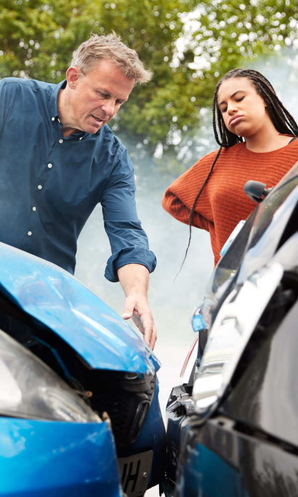 Georgia car accident attorneys in Carrollton - image of a man and a woman behind two wrecked cars